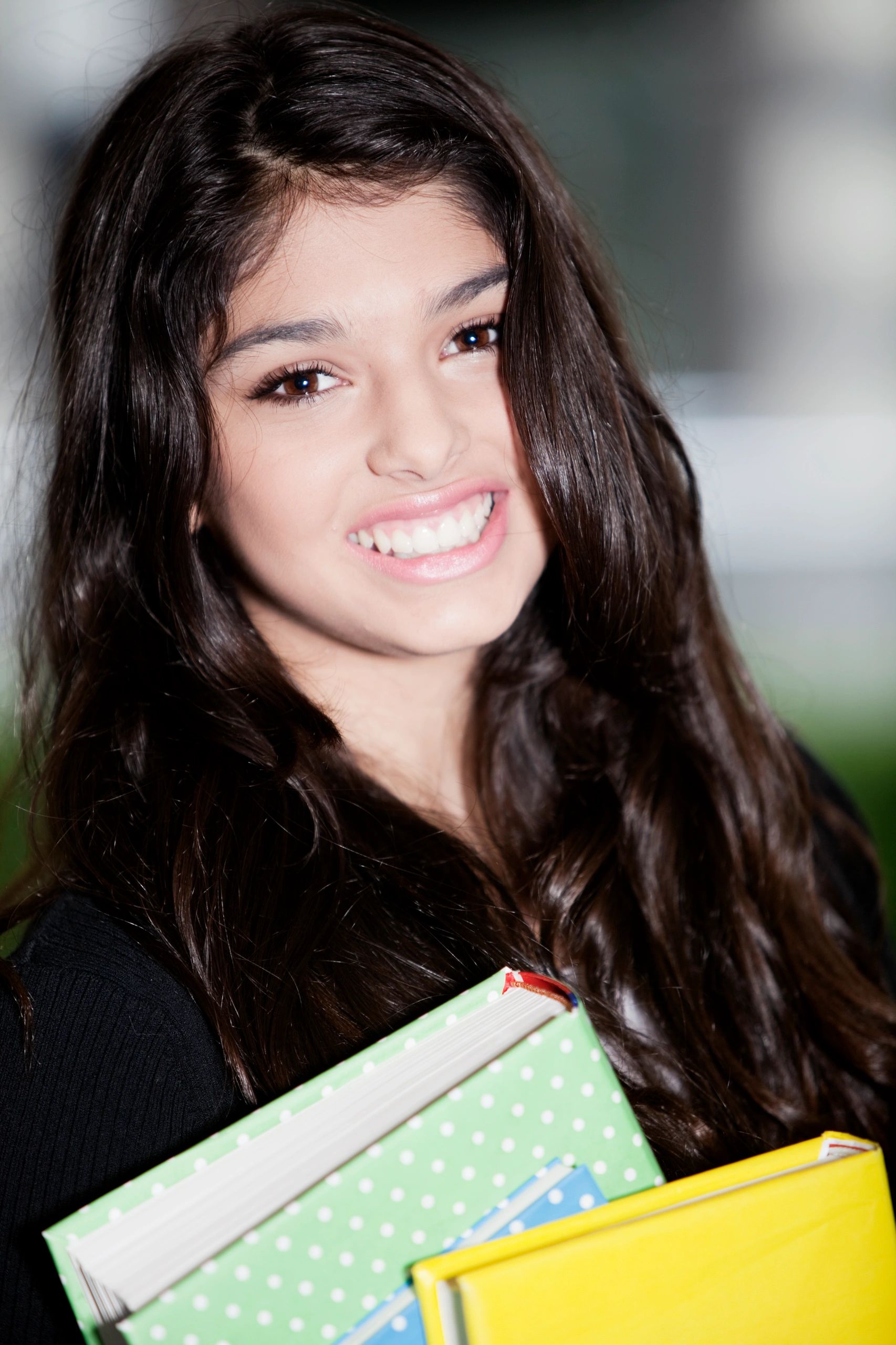 Smiling student holding books