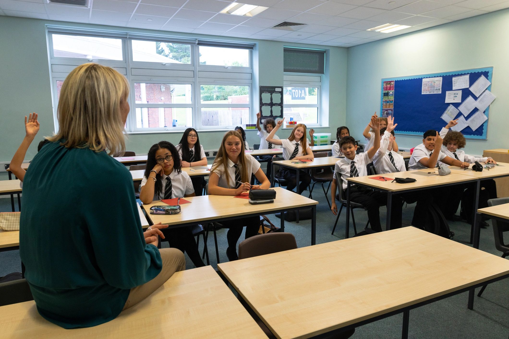 Teacher leading students in a bright classroom